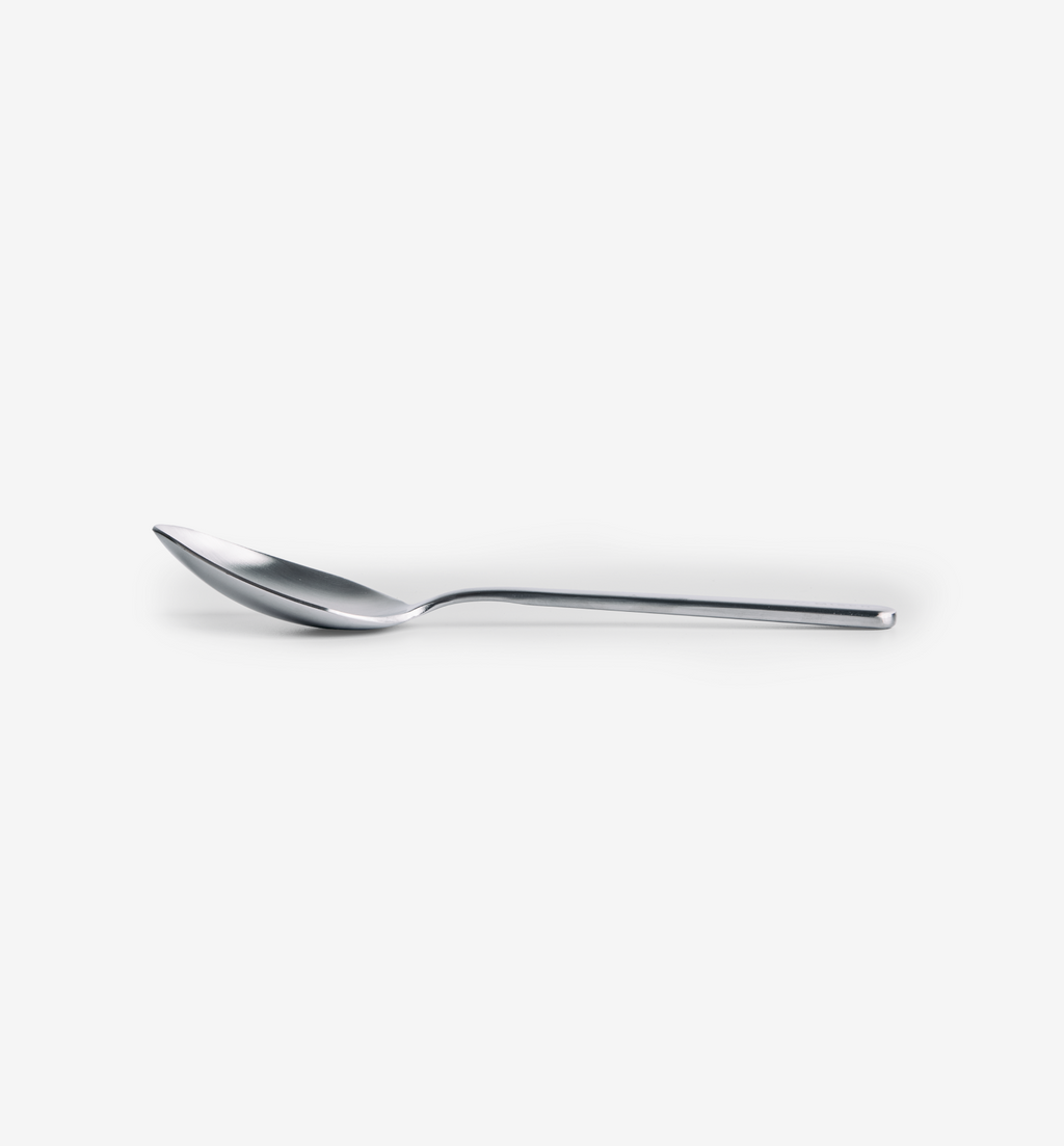 Polished stainless steel spoon with slim tapered handle and pointed bowl